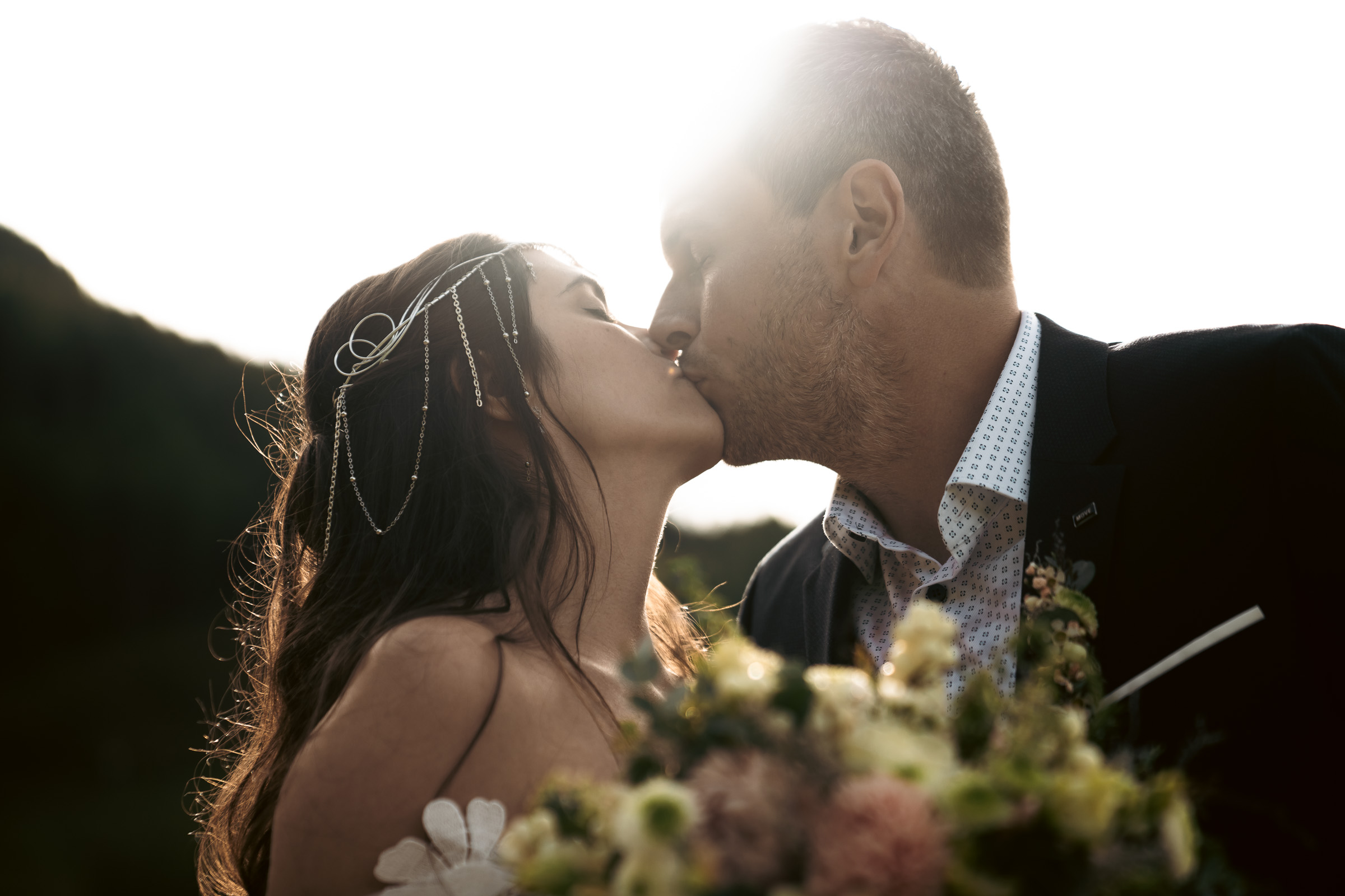 Couple kissing at sunset against the Dolomites