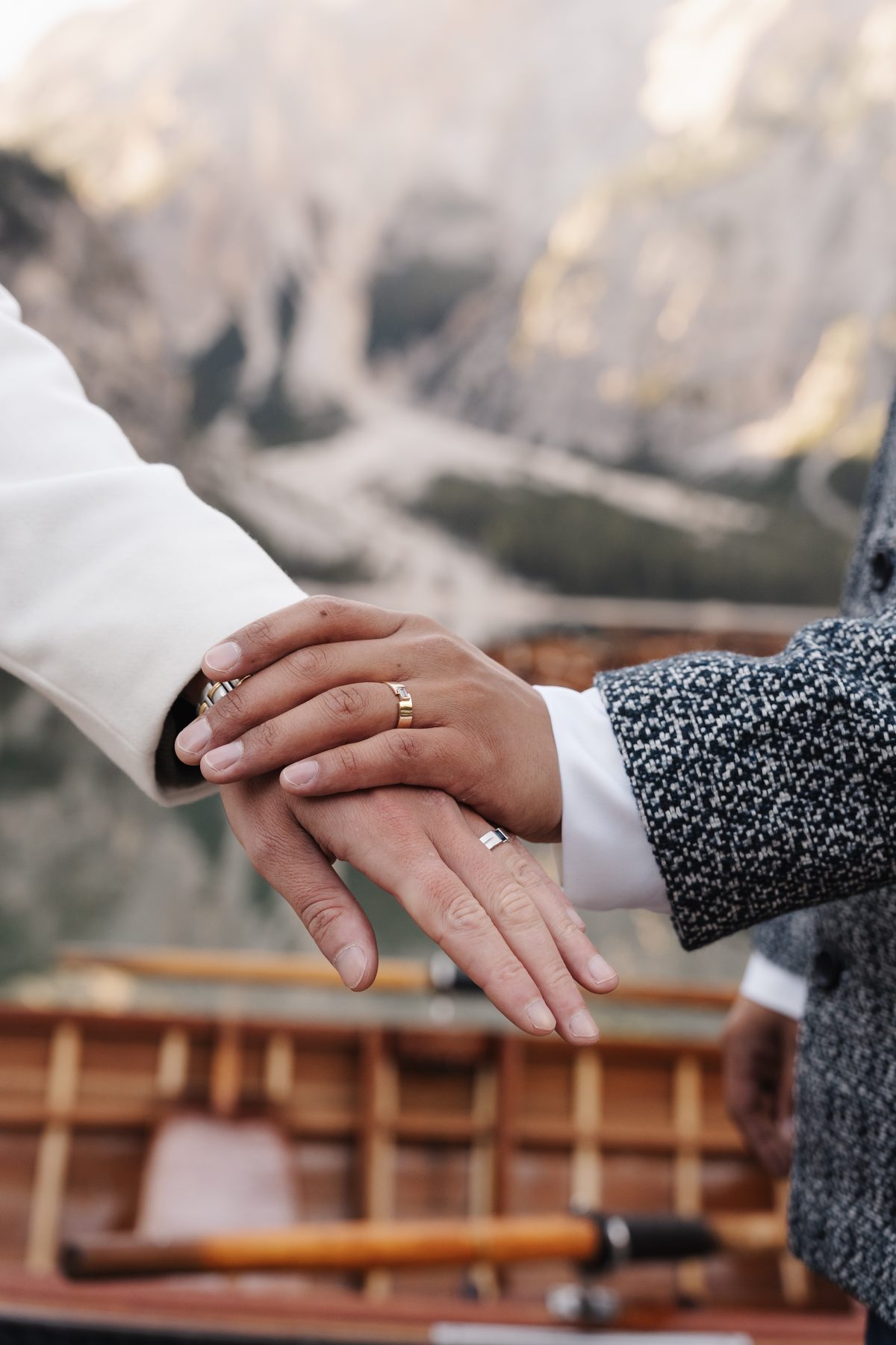 Hands with wedding rings, the boats in the background