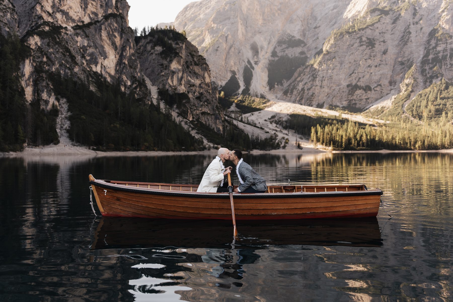 A rowing boat alone on Lago di Braies below the rock faces