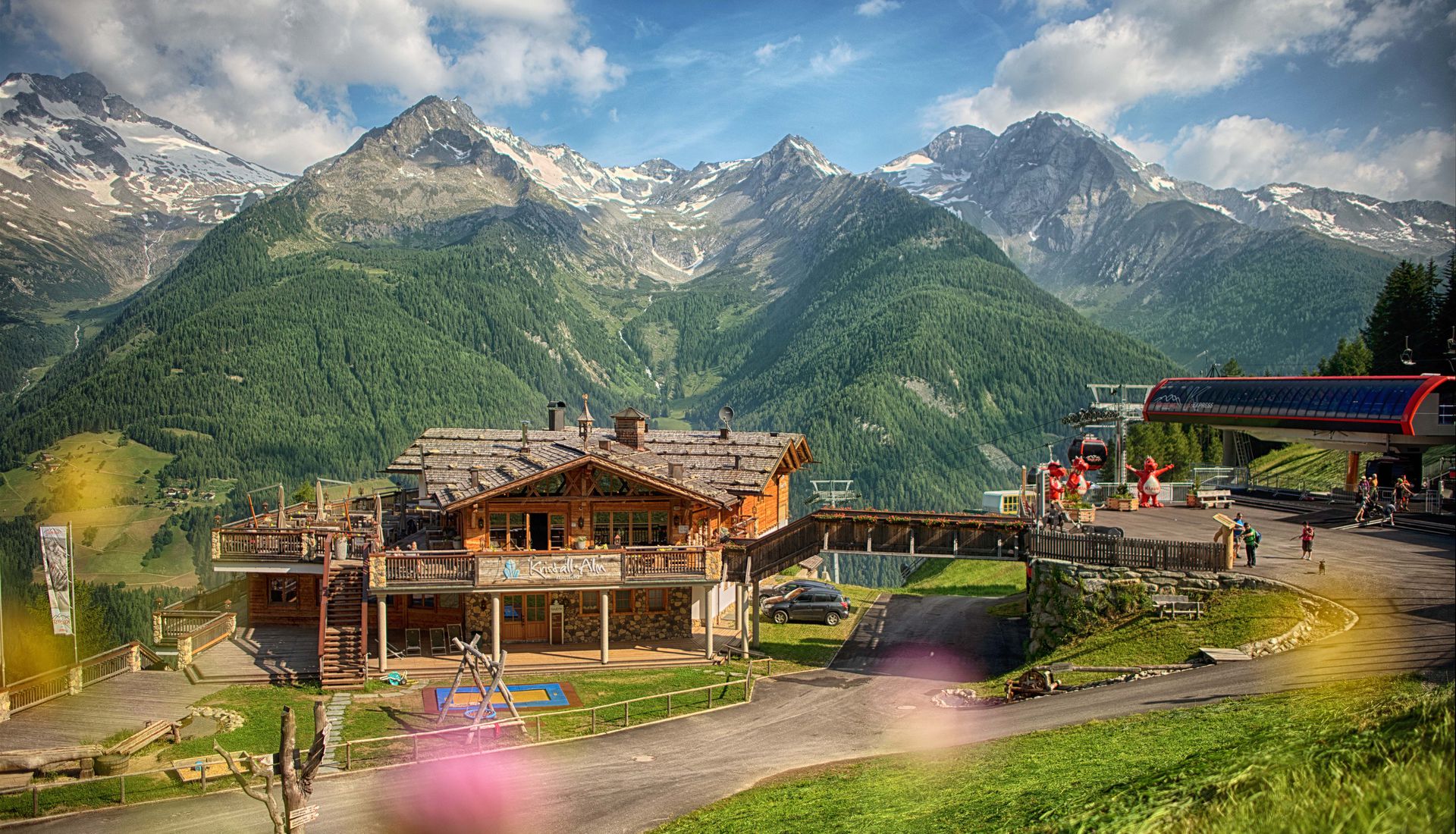 The Kristallalm in summer at the top station, with the peaks above the Ahrntal behind it