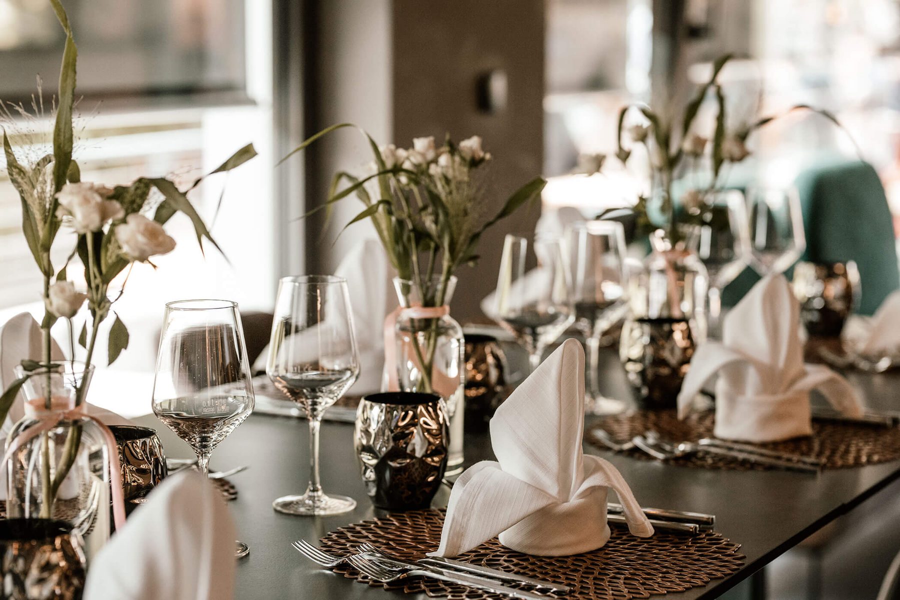 Laid table with glasses and flowers