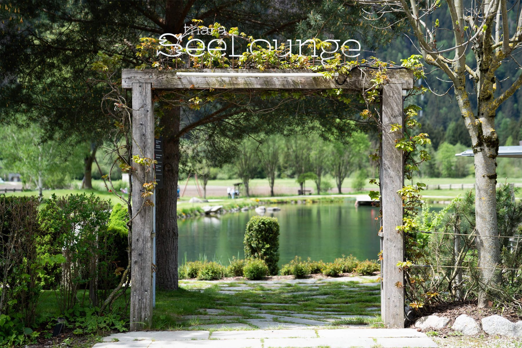 Wooden arch at the entrance, the lake behind it